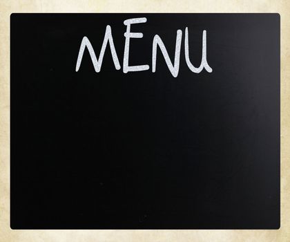 The word "Menu" handwritten with white chalk on a blackboard