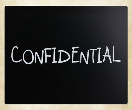 The word "Confidential" handwritten with white chalk on a blackboard