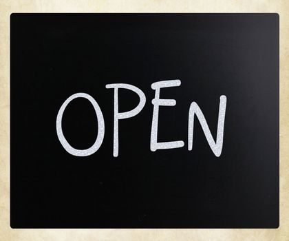 The word "Open" handwritten with white chalk on a blackboard