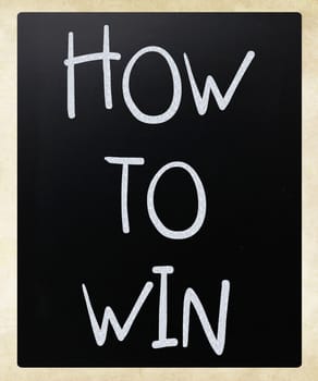 "How to win" handwritten with white chalk on a blackboard