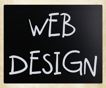 "Web design" handwritten with white chalk on a blackboard