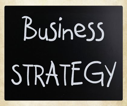 "Business strategy" handwritten with white chalk on a blackboard