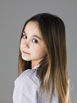 Portrait of a young girl on grey background