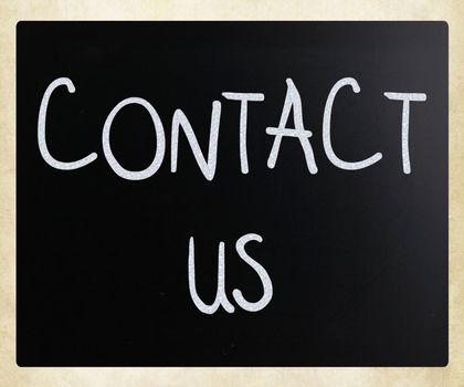 "Contact Us" handwritten with white chalk on a blackboard