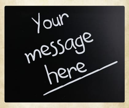 "Your message here" handwritten with white chalk on a blackboard