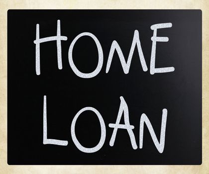 "Home loan" handwritten with white chalk on a blackboard