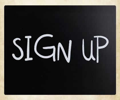 "Sign up" handwritten with white chalk on a blackboard