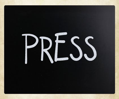 "PRESS" handwritten with white chalk on a blackboard