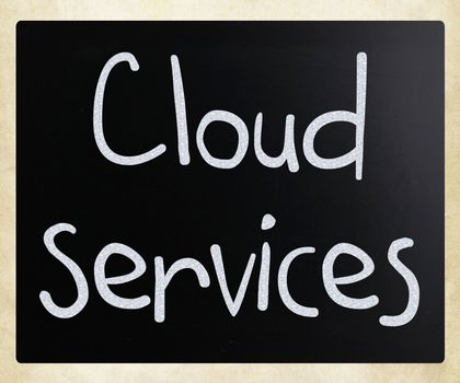 "Cloud services" handwritten with white chalk on a blackboard