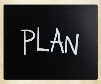 "Plan" handwritten with white chalk on a blackboard