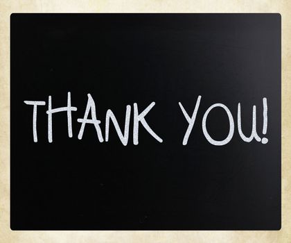 "Thank you" handwritten with white chalk on a blackboard