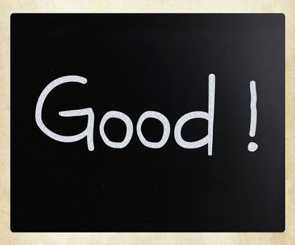 "Good" handwritten with white chalk on a blackboard