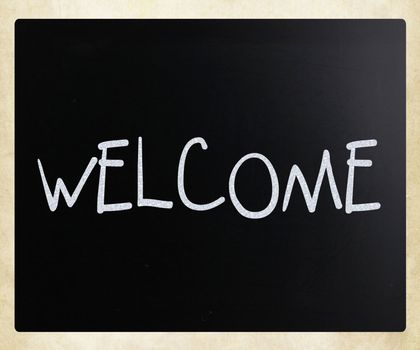 "Welcome" handwritten with white chalk on a blackboard