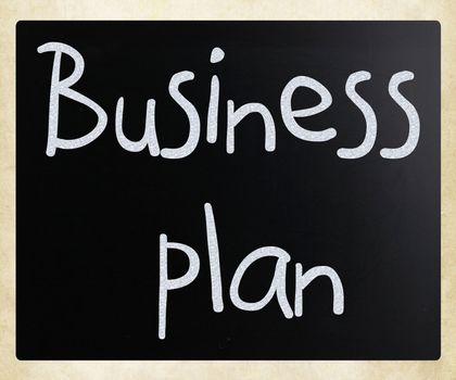 "Business plan" handwritten with white chalk on a blackboard