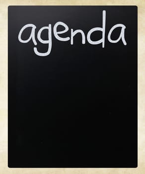 "AGENDA" handwritten with white chalk on a blackboard