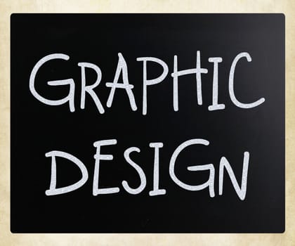 "Graphic design" handwritten with white chalk on a blackboard