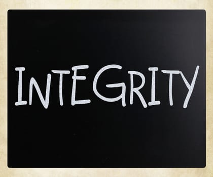 "Integrity" handwritten with white chalk on a blackboard
