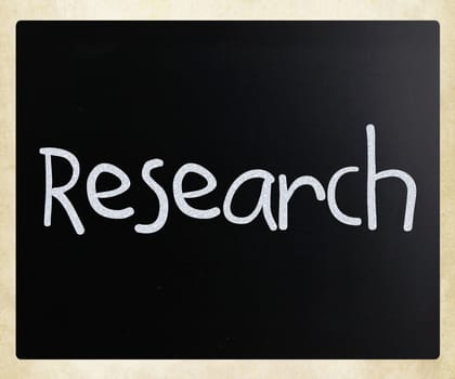 "Research" handwritten with white chalk on a blackboard