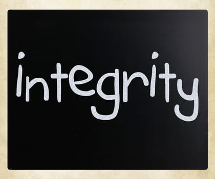 "Integrity" handwritten with white chalk on a blackboard