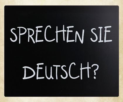 "Sprechen Sie Deutsch?" handwritten with white chalk on a blackboard