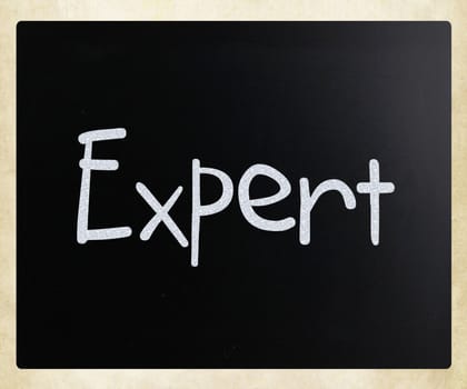 The word "Expert" handwritten with white chalk on a blackboard