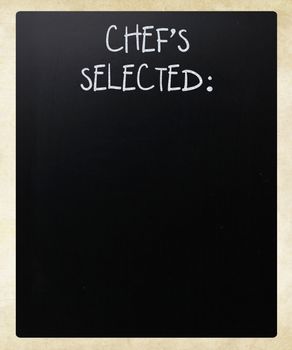 "Chef's Selected" handwritten with white chalk on a blackboard