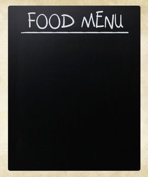 "Food menu" handwritten with white chalk on a blackboard