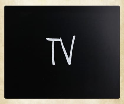 "TV" handwritten with white chalk on a blackboard