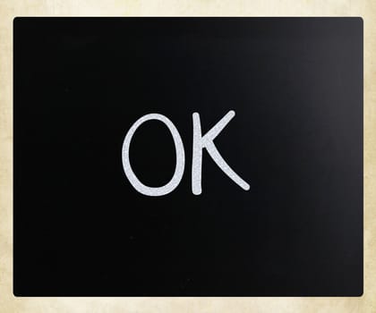 "OK" handwritten with white chalk on a blackboard