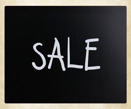 "Sale" handwritten with white chalk on a blackboard