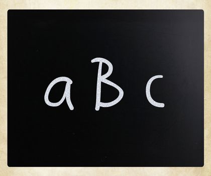 "abc" handwritten with white chalk on a blackboard