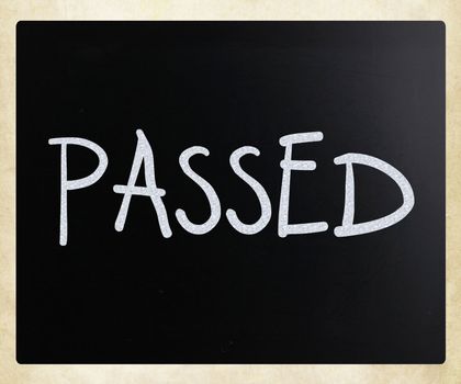 "Passed" handwritten with white chalk on a blackboard