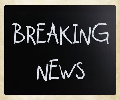 "Breaking news" handwritten with white chalk on a blackboard
