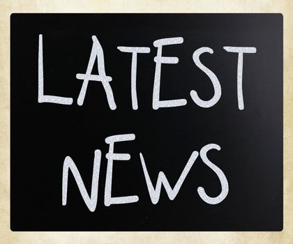 "Latest news" handwritten with white chalk on a blackboard