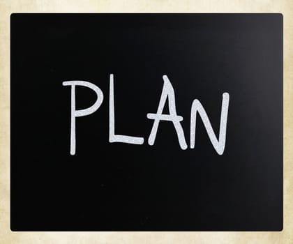 "Plan" handwritten with white chalk on a blackboard