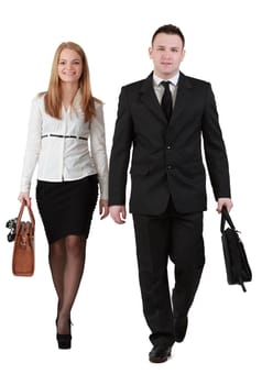 Young couple walking to the camera against a white background.