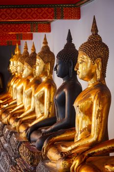 Sitting Buddha statues in Buddhist temple Wat Pho, Bangkok, Thailand