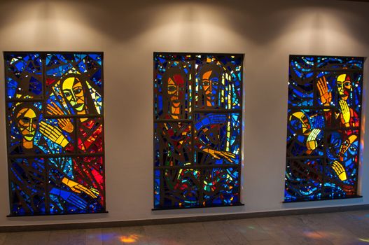 bright stained-glass church windows picturing religious scenes