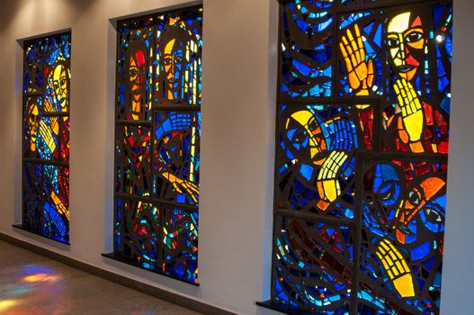 bright stained-glass church windows picturing religious scenes
