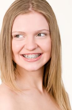 Beautiful young girl with brackets on teeth close up
