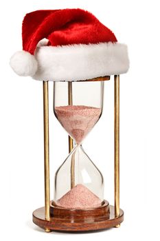 Christmas is coming concept - hourglass  with Santa Claus hat isolated on white background