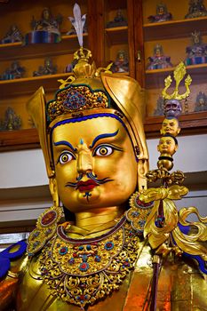 Gilded statue of Guru Padmasambhava in Tsuglagkhang temple. McLeod Ganj, Himachal Pradesh, India