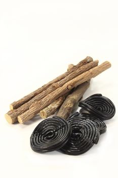 some pieces of licorice and licorice snails on a white background