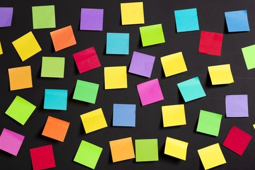 background image of multicolor notes on a black board