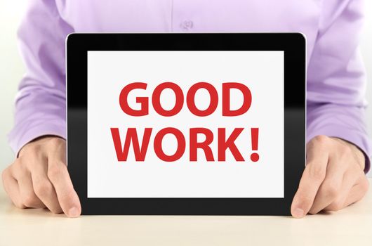 Manager holding tablet pc with "Good Work" text on screen.