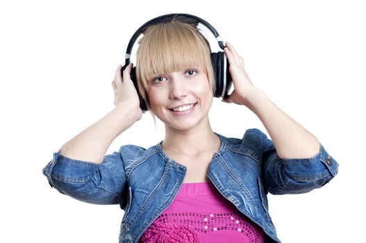 Young attractive woman listing to music with headphones against white background