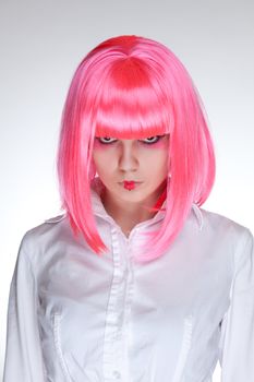 Serious looking woman with oriental make-up, studio shot over white background 