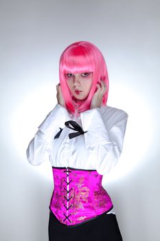 Young surprised woman dressed in oriental corset, studio shot over white background 