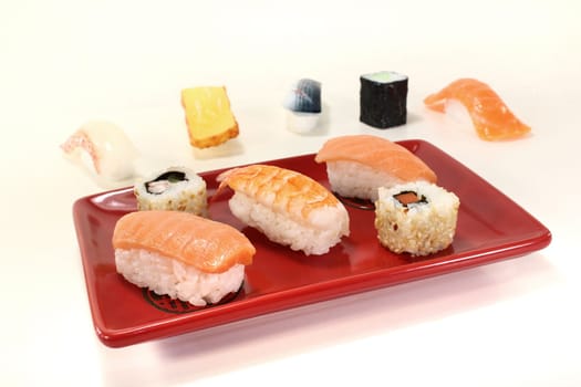 Japanese sushi with fresh salmon, shrimp, carrots and cucumber