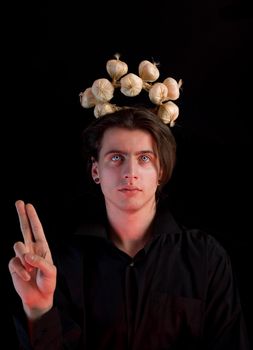 Saint Vampire with garlic halo, isolated on black background 